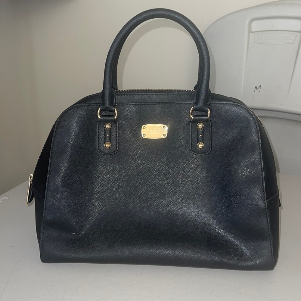 Micheal Kors hand bag. Black with gold trim. Authentic